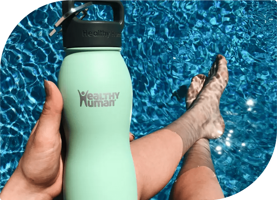 Relaxing by the Pool: Person Holding Healthy Human Bottle in a Comfortable Sitting Position