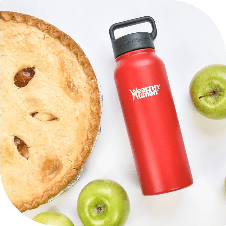 Bottle Surrounded by Green Apples - A Crisp and Fresh Presentation